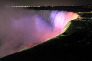 Niagara Falls lit up with multi color lights at night