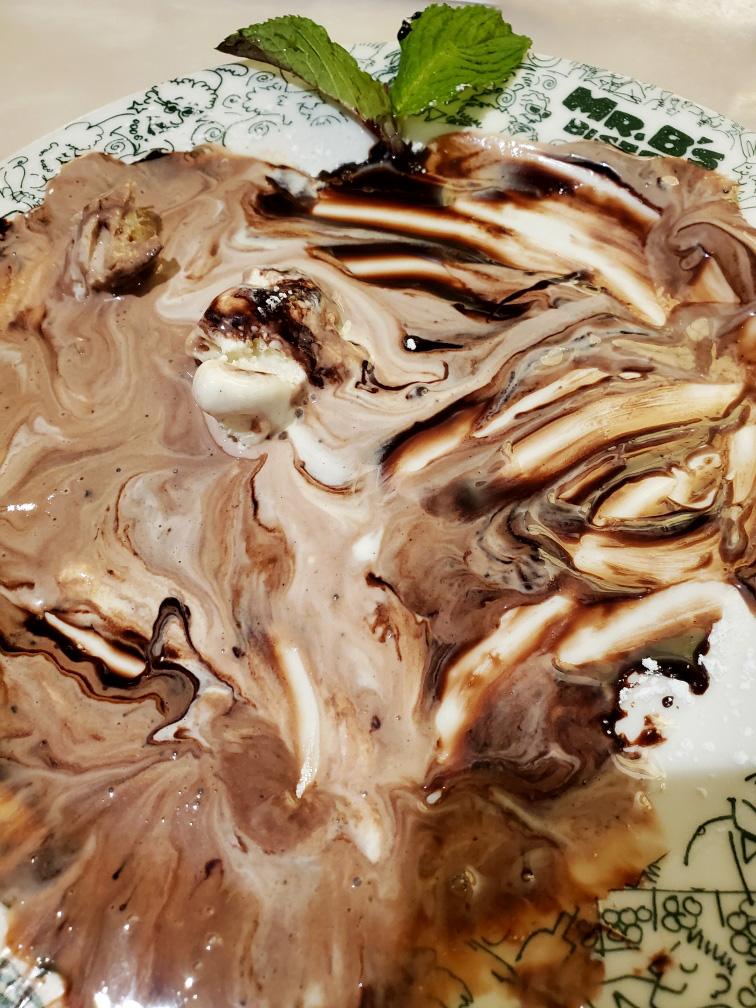 Melted chocolate ice cream mixed with cream swirls 