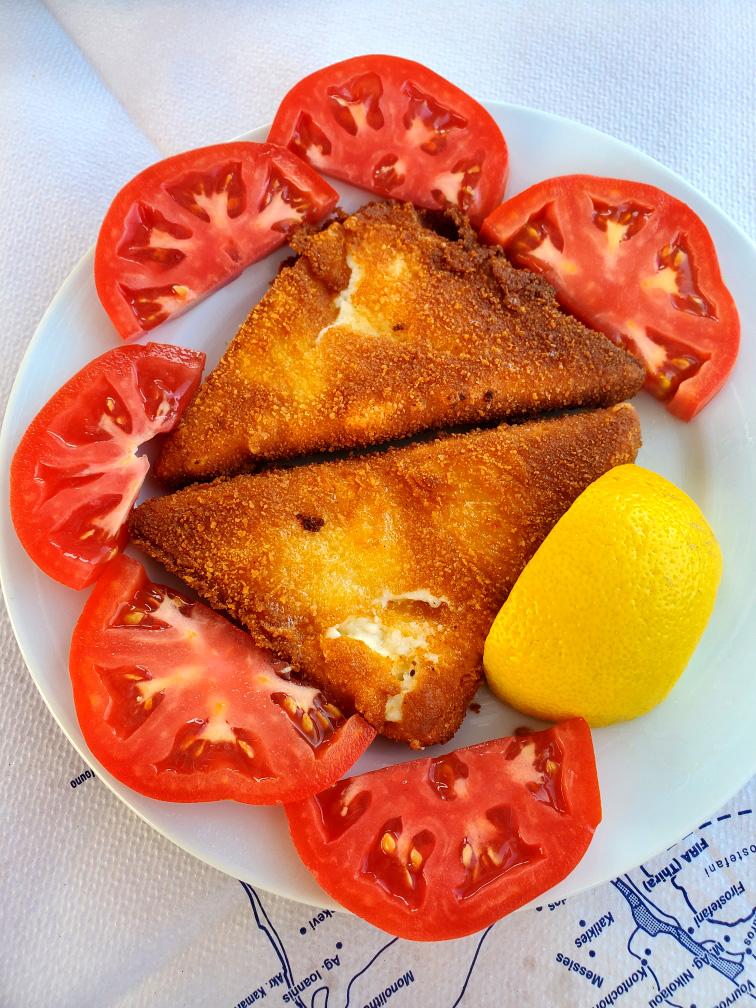 Grilled saginaki and sliced tomatoes. Santorini Greece