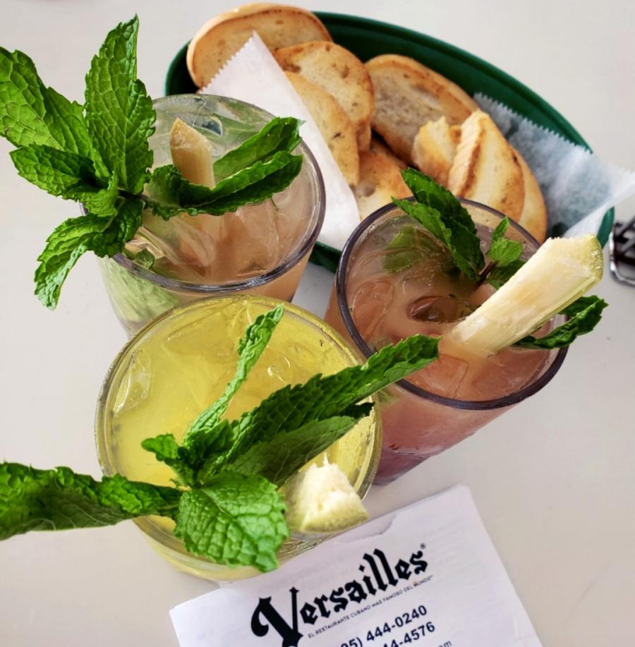 Three assorted mojito drinks with sprigs of mint